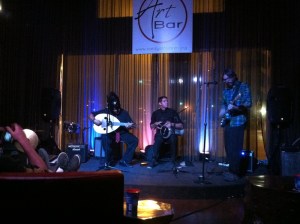 E-Rock, left, wore his Spartan helmet and played the oud alongside his friends Sam, center, and Stephen.