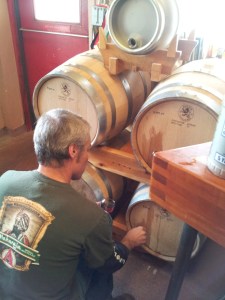 Brewer Rod Tweet pours a small sample of Flemish Red from the barrels inside Second Street Brewery.