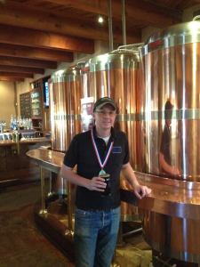 Blue Corn brewer James Warren shows off his GABF gold medal for his Gold Medal Oatmeal Stout. (Photo courtesy of Blue Corn)