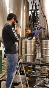 Brandon, left, getting in the way gathering social media content while Franz stirs in the mash.