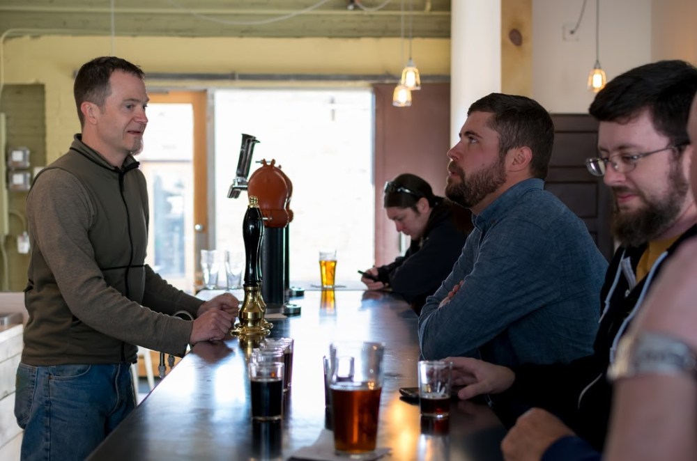 Sidetrack's Dan Herr serves Red Door brewmaster Wayne Martinez, while a certain beer writer has a weird look on his face to the far right.